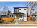 Charming two-story home with black and white siding, front porch, and modern design at 2111 S Franklin St, Denver, CO 80210