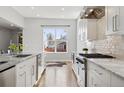 Bright kitchen with stainless steel appliances, marble countertops, and hardwood floors at 2111 S Franklin St, Denver, CO 80210