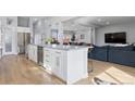 Kitchen island with stainless steel appliances and view into living area at 2111 S Franklin St, Denver, CO 80210