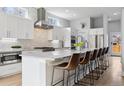 Open kitchen with stainless steel appliances, a large island, and barstool seating at 2111 S Franklin St, Denver, CO 80210