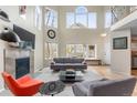 Sun-filled living room boasting high ceilings, a fireplace, and large windows at 7712 S Monaco E Cir, Centennial, CO 80112