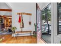 Open entryway leads to sunlit reading room, showcasing hardwood floors and a natural, woodsy aesthetic at 160 Bristlecone Way, Boulder, CO 80304