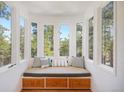 Bay window reading nook with bench seating overlooking beautiful tree view at 160 Bristlecone Way, Boulder, CO 80304