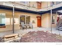 Exterior condo courtyard view with seating area and orange entry doors at 2345 N Clay St # 6, Denver, CO 80211