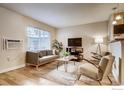 Inviting living room with hardwood floors, large window, and neutral decor at 2345 N Clay St # 6, Denver, CO 80211