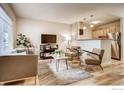 Bright living room featuring hardwood floors, modern furnishings, and open layout at 2345 N Clay St # 6, Denver, CO 80211