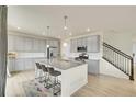 Modern eat-in kitchen with gray cabinets, granite countertops, stainless steel appliances, and a large island at 4884 St Vrain Rd, Firestone, CO 80504