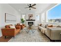Bright living room featuring a tiled fireplace, modern furniture, and a large window with neighborhood views at 1136 Hillside Ln, Louisville, CO 80027