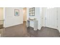 Bright foyer with hardwood floors, console table, stylish mirror, and white walls at 6311 Stable View St, Castle Pines, CO 80108