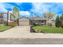 Traditional home with a brick facade, two-car garage, and vibrant landscaping at 4408 E 107Th Pl, Thornton, CO 80233