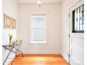 Bright entryway featuring hardwood floors, white walls, and vintage-style accents at 3719 W 30Th Ave, Denver, CO 80211