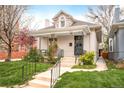 Front exterior of a charming home with decorative iron porch railing and green lawn at 3719 W 30Th Ave, Denver, CO 80211