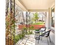 Inviting front porch with wrought iron railings, seating, and lush greenery at 3719 W 30Th Ave, Denver, CO 80211