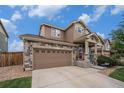 Home with a stone facade and an attached two-car garage and a cute porch with a patriotic star at 7877 E 139Th Pl, Brighton, CO 80602