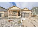 Inviting single-Gathering home with a covered front porch, two-car garage, and low-maintenance gravel landscaping at 45831 Silverdrop Ave, Bennett, CO 80102
