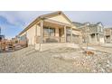 This single-Gathering home boasts a covered front porch and low-maintenance gravel landscaping in the front yard at 45831 Silverdrop Ave, Bennett, CO 80102