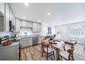 Open-concept living space featuring modern kitchen, dining area, and comfortable living room at 46542 Avery Ln, Bennett, CO 80102