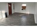 Newly renovated living room featuring wood floors, freshly painted white walls, and a contemporary aesthetic at 7170 W Mississippi W Ave, Lakewood, CO 80226