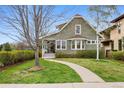 Inviting two-story home with a well-kept lawn and landscaping leading to the front porch at 2595 S Adams St, Denver, CO 80210