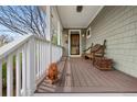 Cozy front porch with a wooden bench, decorative lion statue, and a charming entrance to the home at 2595 S Adams St, Denver, CO 80210