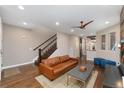 Open living space featuring hardwood floors, a staircase, and views into the dining area and kitchen at 2222 N Washington St, Denver, CO 80205