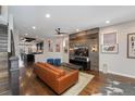 Open-concept living room featuring hardwood floors, a wood-accent wall, and modern decor at 2222 N Washington St, Denver, CO 80205