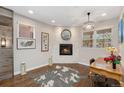Cozy office space with a fireplace, hardwood floors, and a stylish light fixture at 2222 N Washington St, Denver, CO 80205