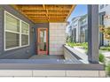 Cozy outdoor balcony area with wood ceiling, brick accents, and neighborhood views at 6791 Navajo Ct, Denver, CO 80221