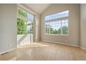 Sun-filled room with vaulted ceiling and large windows, showcasing hardwood floors and inviting ambiance at 9602 Indian Wells Dr, Lone Tree, CO 80124