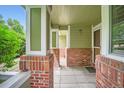 Covered front porch with brick pillars provides a cozy outdoor space at 1851 S Marshall Cir, Lakewood, CO 80232