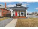 Attractive exterior view of the home featuring a red front door and covered porch at 3800 Umatilla St, Denver, CO 80211