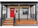 Inviting front porch with stylish railings and a vibrant red front door at 3800 Umatilla St, Denver, CO 80211