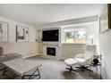 Comfortable living room with fireplace, large window and contemporary decor at 13072 Westlake Pl, Broomfield, CO 80020