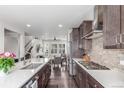 Modern kitchen with stainless steel appliances and stylish wood cabinetry at 15843 E Broncos Pl, Englewood, CO 80112