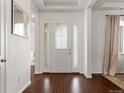 Bright foyer with hardwood flooring and an inviting front door at 5693 Missoula Trl, Castle Rock, CO 80108
