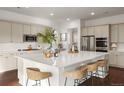 Bright kitchen features a large center island with seating, stainless steel appliances, and ample counter space at 5693 Missoula Trl, Castle Rock, CO 80108