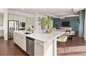 Open concept kitchen with stainless steel appliances, a large island with seating, and hardwood floors at 5693 Missoula Trl, Castle Rock, CO 80108
