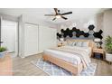 Stylish bedroom featuring a modern accent wall, ceiling fan and natural light at 1707 Ostia Cir # 46, Lafayette, CO 80026