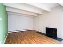 Bright living room features hardwood floors, fireplace, and white-painted brick accent wall at 655 N Pearl St # 208, Denver, CO 80203