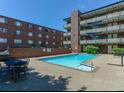 Apartment buildings overlook a refreshing community pool with ample space for lounging at 655 N Pearl St # 208, Denver, CO 80203