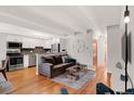 Open living room features hardwood floors, a modern kitchen, and comfortable seating, perfect for entertaining guests at 50 N Clarkson St # 305, Denver, CO 80218