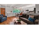 Bright living room with an open floor plan, hardwood floors, large windows, and comfortable seating for guests at 50 N Clarkson St # 305, Denver, CO 80218