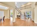 Stunning foyer with a grand staircase and wood floors at 17826 E Cloudberry Dr, Parker, CO 80134