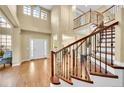 Gorgeous foyer with soaring ceilings, wood floors, and a winding staircase at 17826 E Cloudberry Dr, Parker, CO 80134