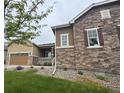 Attractive two-story home showcasing a combination of stone and siding, paired with manicured landscaping at 3855 Old Oaks St, Castle Rock, CO 80104