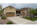 Charming two-story home featuring a well-maintained lawn, stone details, and a convenient two-car garage at 3855 Old Oaks St, Castle Rock, CO 80104