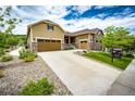 Beautiful two-story home with a three car garage, stone accents, and landscaped front yard for excellent curb appeal at 3855 Old Oaks St, Castle Rock, CO 80104
