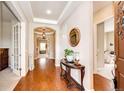 Elegant foyer features tray ceiling, hardwood floors, and decorative details adding warmth and style to this home at 3855 Old Oaks St, Castle Rock, CO 80104