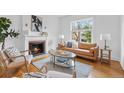 Cozy living room featuring a fireplace and hardwood floors at 408 E 1St Ave, Denver, CO 80203