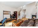 Bright living room with hardwood floors, fireplace, and staircase at 57 Audrey Cir, Breckenridge, CO 80424